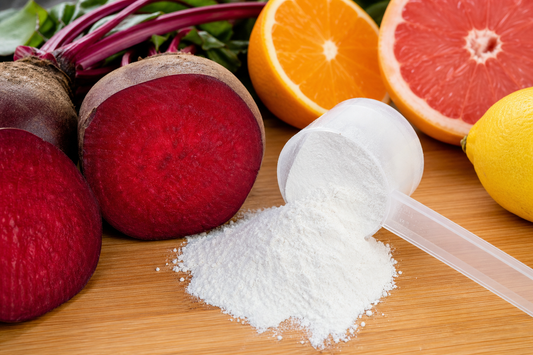 A realistic close‑up of fresh beetroot, citrus fruits, and a handful of L‑Citrulline powder spilling onto a wooden cutti